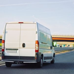 white cargo van on the road